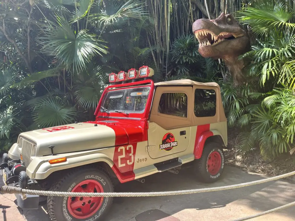 Jurassic Park jeep with a dinosaur behind it